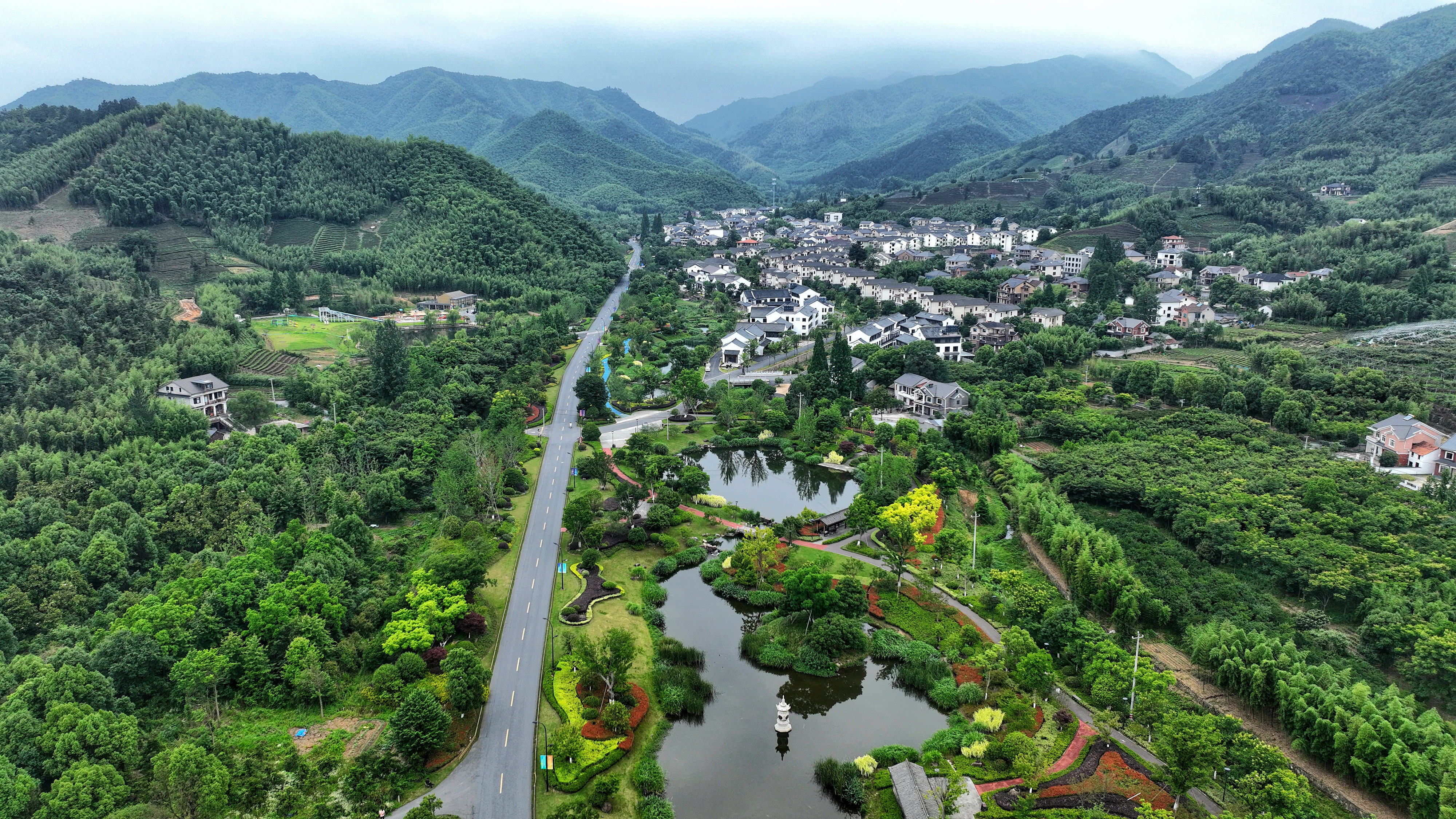 2023年6月6日，杭州余杭區(qū)徑山鎮(zhèn)鄉(xiāng)村，生態(tài)碧水、沿路花海與村莊農(nóng)房相映成趣，構(gòu)成一幅美麗的山水田園畫。